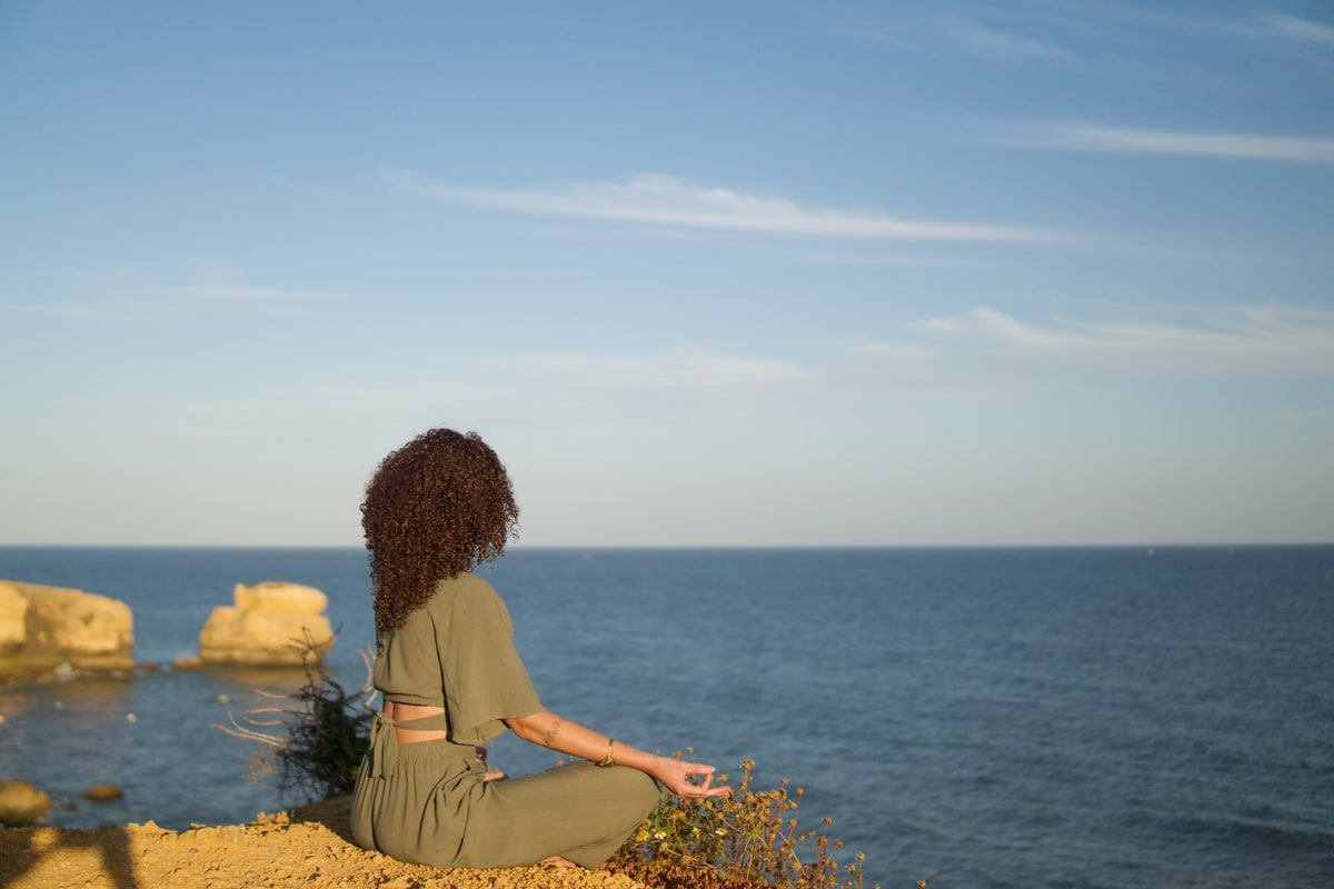 Liza meditating beside the Algarve coast